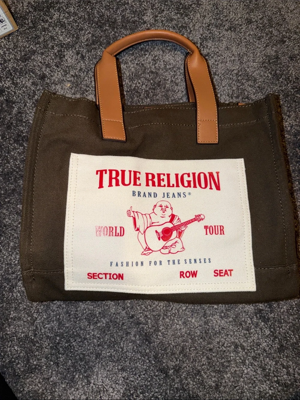 True Religion Brown Canvas Tote with Tan Leather Handles and Red Logo Patch
